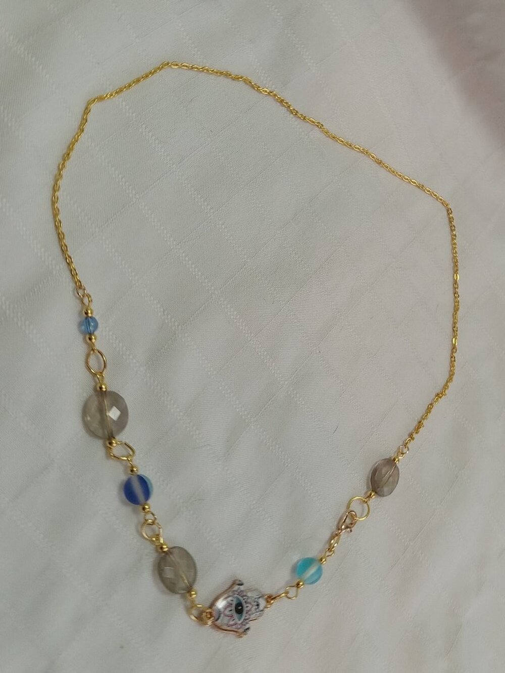 A pretty, minimalist, asymmetrical, reversible handmade necklace